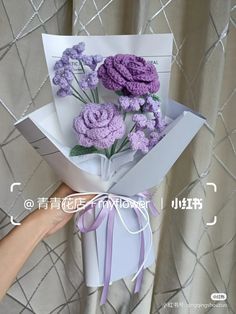 a person is holding a bouquet of flowers