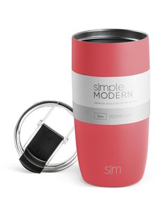 a red tumbler cup next to a black and white lid with the word simple modern on it