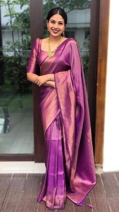 a woman in a pink sari posing for the camera