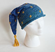 A classic night cap, made from a cozy combination of merino and cotton yarn felted in a washing machine. A winter sky motif fades from brim to tip, warm to dark blue. A gold tassel picks up on sparkly stars that dot the hat. Complete instructions are provided for felting the hat to your precise size. Crochet Night Cap, Pajama Hat, Night Hat, Cap Patterns, Winter Sky, Knitting Patterns Free Cardigans, Yarn Thread, Knitted Wit, Night Cap