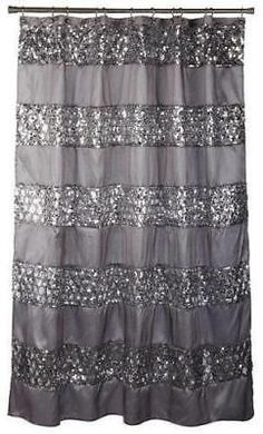 a shower curtain with silver sequins on the bottom and black trim around it