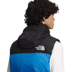 Inspired by The North Face's 1996 Nuptse, the 1996 Retro Nuptse Vest brings throwback style to our look and is versatile enough for our adventures around the city or on the trail. Its lofty goose down insulation traps your body heat for reliable warmth on cold winter days, and the durable face fabric is water-resistant to keep you dry if flakes start to fall. The hood protects your face from the wind, but can be easily stowed into the collar when the weather is fair, while an adjustable hem The North Face Nuptse 1996, North Face 1996 Nuptse, Nuptse Vest, The North Face 1996 Retro Nuptse, The North Face 1996, North Face 1996, Sonic Blue, North Face Vest, North Face Nuptse