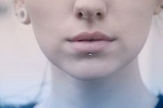 a woman with piercings on her nose looking at the camera