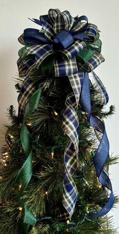 a christmas tree decorated with blue and green ribbons