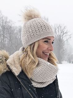 a woman wearing a hat and scarf in the snow