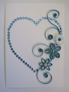 the letter r is made up of metal beads and flowers on a white background with blue accents