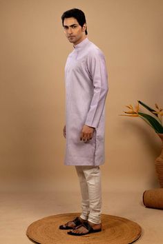 Purple handloom silk kurta with wave highlight across the chest. Paired with an off white churidar. - Aza Fashions