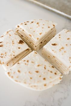 tortilla slices cut into four pieces on a counter