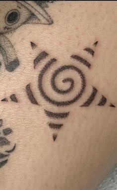 a close up of a person's arm with tattoos on it and an animal