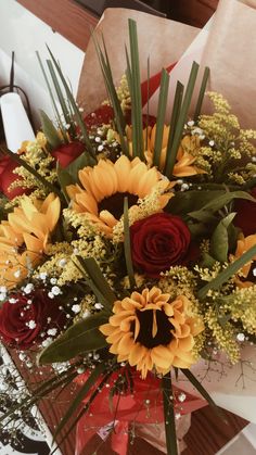 a bouquet of sunflowers, roses and baby's breath