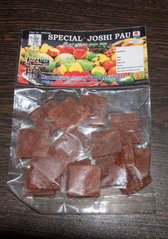 pieces of brown sugar sitting on top of a plastic bag next to a package of fruit