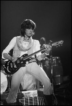 a man with an electric guitar on stage