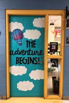 a door with the words the adventure begins painted on it and an air balloon in the sky