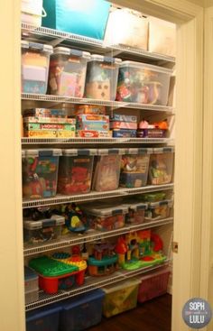 a closet filled with lots of toys and bins on the shelves next to each other