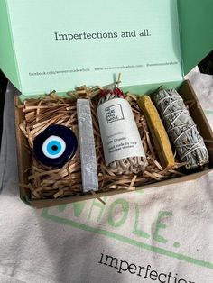 an open box containing soaps, toothpaste and eyeballs on a table