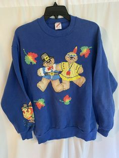 a blue sweater with two bears on it