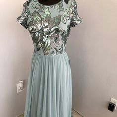 Short Sleeve Sequin To, Floral Design In Silver And Aqua Sequin Especially In Back. Semi Full Knit Jersey Skirt Sparkly Formal Dress, Black Lace Gown, Ruffled Gown, Dresses Short Sleeve, Evening Dresses With Sleeves, Full Length Gowns, Black Dress Formal, Jersey Skirt, Sleeveless Gown