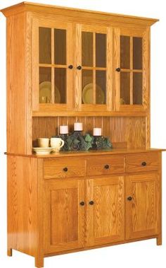 a wooden hutch with glass doors and candles on it's front door,