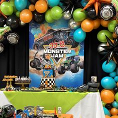 a monster jam themed birthday party with balloons and streamers on the wall, table