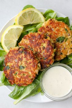 lemony tuna cakes with lemon pepper mayonnaise are served on a bed of lettuce