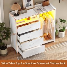 a white dresser with drawers and clothes rack in the corner next to a potted plant