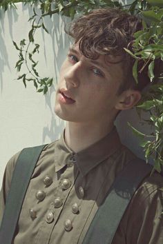 a young man wearing suspenders and a shirt