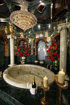 a fancy bathroom with a large jacuzzi tub and chandelier