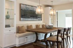 a dining room table with chairs and benches