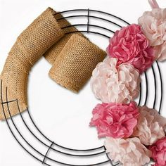 a wreath with burlap and pink flowers on it