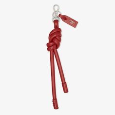 Oversized knot-shaped key ring, inspired by the long zip-pulls on this season’s new bags. The clip allows it to be attached like a charm to bags or other accessories. Customised with logo tag. Made of soft, red leather. Palladium-finish metalware. Made in Italy. One Size Leather Key Case, New Bags, Leather Crafts, Leather Keyring, Soft Red, Fragrance Gift, Clutch Pouch, Logo Tag, Women Essentials