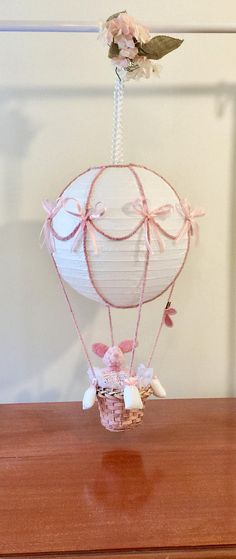 a white paper hot air balloon with pink flowers