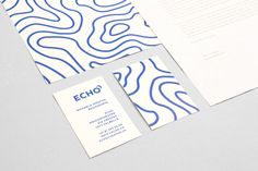 two business cards on top of each other with blue and white lines in the background