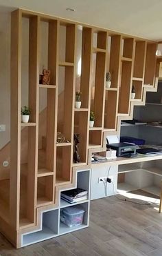 a room with wooden shelves and bookshelves on the wall next to a desk