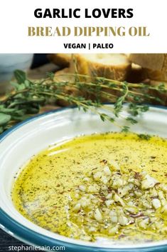 garlic lover's bread dipping oil in a white bowl with herbs on top