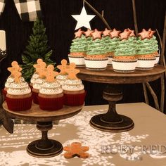 cupcakes and cookies on a table with christmas decorations