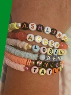 four bracelets with words on them are shown in front of a woman's arm