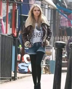 a young woman is walking down the street