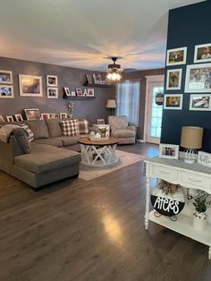 a living room filled with furniture and pictures on the wall