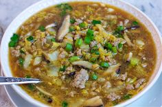 a bowl of soup with meat and vegetables