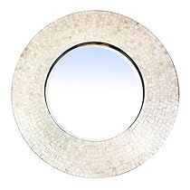 a round mirror with white mosaic tiles on the bottom and sides, against a white background