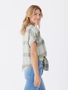 The Sheena Woven Button Up is crafted from 100% sustainable lenzing viscose for guilt-free fashion. It features a drop shoulder design and tie front detail, adding an elevated and stylish touch to any outfit. Casual Tie Neck Tops For Summer, Casual Tied Tops For Summer, Casual Beach Tops With Tied Details, Casual Tied Tops For Beach, Casual Summer Blouse With Tie Waist, Casual Tied Top For Spring, Casual Short Sleeve Blouse With Tie Sleeves, Casual Tops With Tie Sleeves For Day Out, Casual Blouse With Tie Sleeves