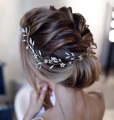 a woman wearing a hair comb with flowers in it