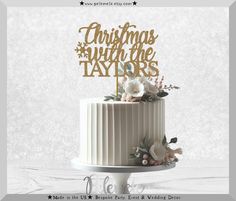 a christmas cake topper with flowers and the words'christmas with the taylors'on it