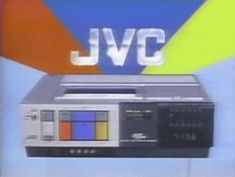 an old television with the jvc logo on it's back side, in front of a multicolored background