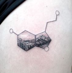 the back of a woman's thigh with mountains and stars on it, as well as two hexagons