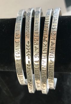 "This listing is for 1 bracelet. Beautifully hand stamped bracelet. 1/8\"x6\". Very sturdy. Fits wrist sizes 6\"-7 1/2\". Made of 12 gauge aluminum. Will not turn your wrist colors. Can fit 52 letters/spaces/hearts. Leave what you would like stamped in the note to seller after purchase. *Hand stamped items are artistically imperfect, unlike mass produced machine made jewelry. Letters will not always line up perfectly and depth may vary slightly, as each letter is stamped with a hammer personally Adjustable Silver Bangle With Custom Name, Personalized Adjustable Bangle For Mother's Day, Personalized Stamped Name Bangle Bracelet, Mother's Day Personalized Adjustable Bangle, Adjustable Silver Name Bracelet With Hand Stamped Details, Silver Adjustable Name Bracelet, Hand Stamped, Hand Stamped Name Bracelet Bangle For Personalized Gift, Hand Stamped Name Bracelet Bangle, Personalized Hand Stamped Name Bangle Bracelet