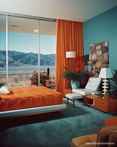 a bedroom with an orange bed and large window overlooking the desert outside, is pictured in this image