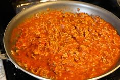 a pan filled with food sitting on top of a stove