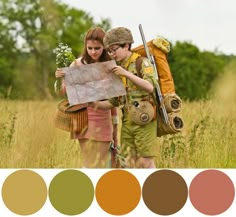 two people are looking at a map in a field with color swatches on it