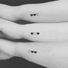 three small hearts tattoo on both arms